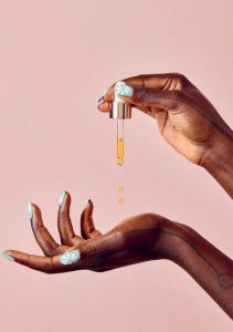 Your Best Skin - A dark-skinned person's hands testing a skincare product